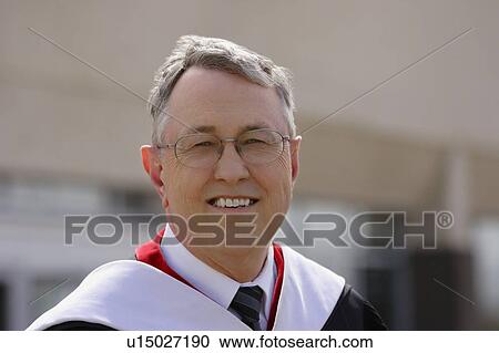 Stock Image - Senior in a graduation gown. Fotosearch