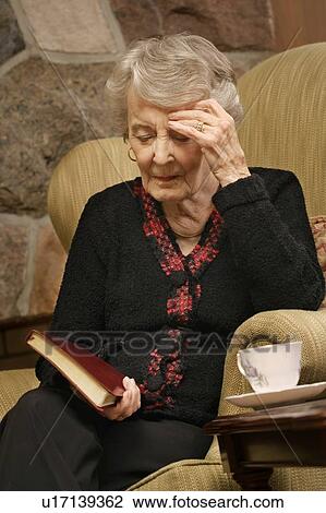 Stock Image - Senior woman in prayer. Fotosearch