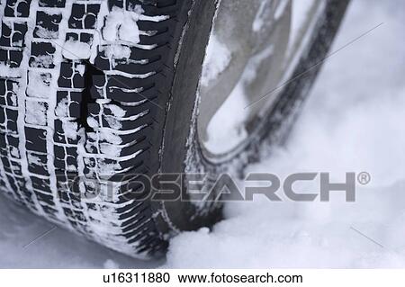 Stock Image - Snowy car tire. Fotosearch