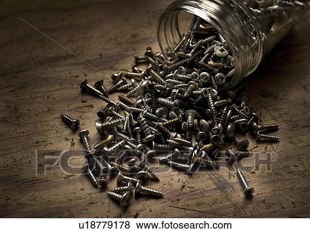 Stock Photo - Spilt jar of screws. Fotosearch