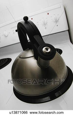 Stock Photograph - Stainless steel tea kettle on stove. Fotosearch