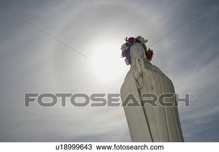 Stock Image - Statue of a woman praying. Fotosearch