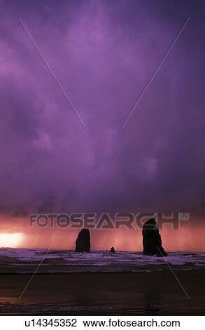 Sunset over needles on the ocean at Cannon Beach View Large Photo Image Stock Image - Sunset over needles on the ocean at Cannon Beach. Fotosearch