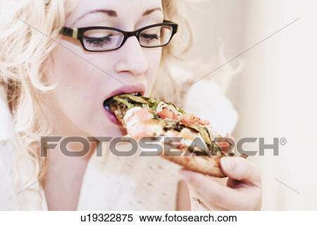 Stock Photography - Woman eating pizza. Fotosearch