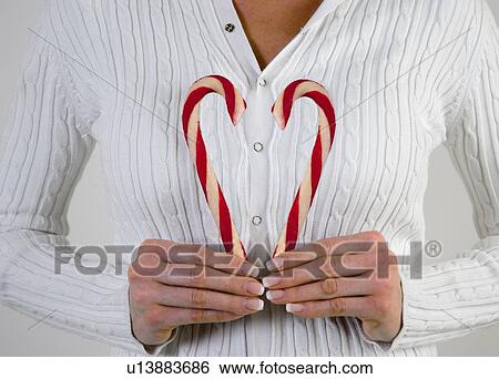 Woman holding Candy Canes View Large Photo Image Stock Photograph - Woman holding Candy Canes. Fotosearch