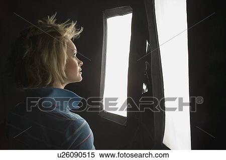 Woman looking into a light View Large Photo Image Stock Photography - Woman looking into a light. Fotosearch
