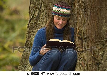 Woman reading a book View Large Photo Image Stock Photo - Woman reading a book. Fotosearch