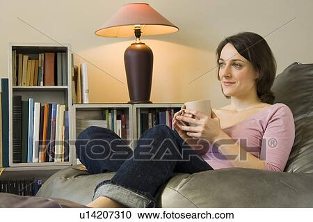 Woman relaxing with a drink View Large Photo Image Stock Image - Woman relaxing with a drink. Fotosearch
