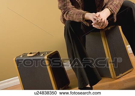 Stock Image - Woman with suitcases. Fotosearch