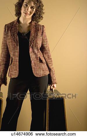 Stock Photograph - Woman with suitcases. Fotosearch