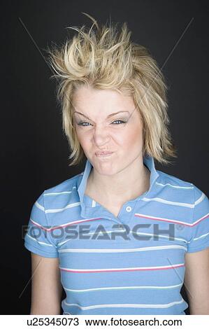 Young blonde woman making a funny face View Large Photo Image Stock Image - Young blonde woman making a funny face. Fotosearch