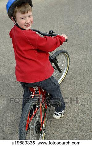 Stock Photography - Young boy a bike. Fotosearch