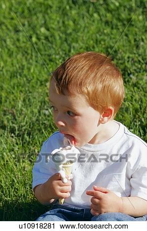 Stock Image - Young boy eating ice cream. Fotosearch