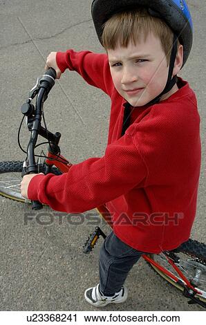 Young boy on bike View Large Photo Image Stock Image - Young boy on bike. Fotosearch