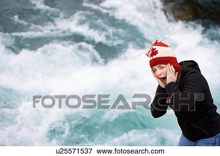 Young person by rushing rapids View Large Photo Image Stock Photo - Young person by rushing rapids. Fotosearch