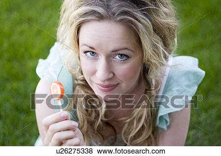 Stock Photo - Young woman with lollipop. Fotosearch