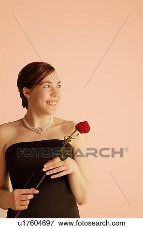 Young woman with rose View Large Photo Image Stock Photo - Young woman with rose. Fotosearch