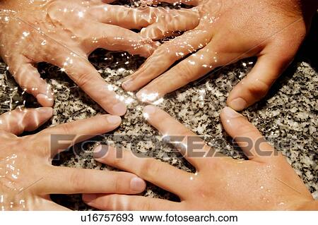 Stock Image - Children's hands touching water. Fotosearch
