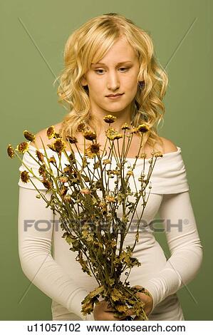 Lady looking at wilted flowers View Large Photo Image Stock Image - Lady looking at wilted flowers. Fotosearch