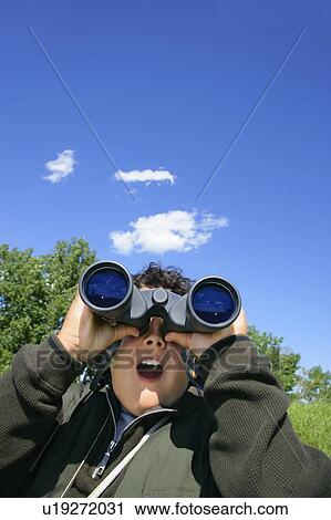 Stock Image - Looking through binoculars. Fotosearch