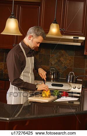 Man cooking in kitchen View Large Photo Image Stock Photography - Man cooking in kitchen. Fotosearch