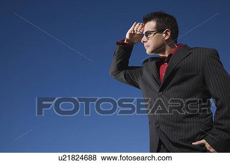 Man in a suit looks into the distance View Large Photo Image Stock Photo - Man in a suit looks into the distance. Fotosearch