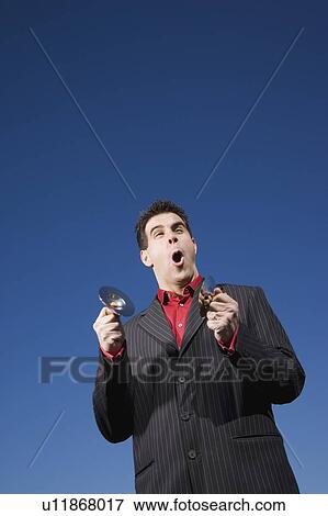 Stock Photo - Man playing child size cymbals and singing. Fotosearch
