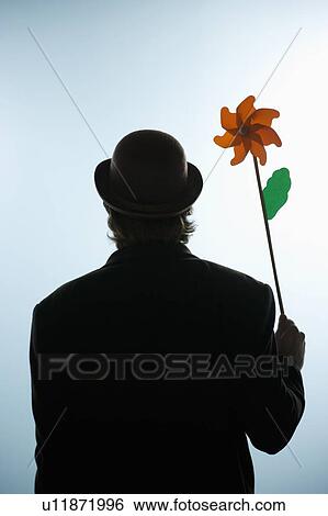 Stock Photograph - Person holding a flower pin wheel. Fotosearch