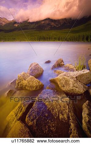 Scenic view across a lake View Large Photo Image Stock Image - Scenic view across a lake. Fotosearch