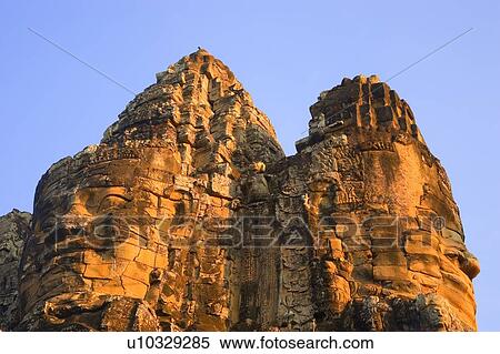 Stone heads on gate Angkor Thom, Siem Reap Cambodia View Large Photo Image Stock Photography - Stone heads on gate Angkor Thom, Siem Reap Cambodia. Fotosearch