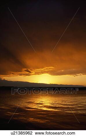 Sunrise through clouds View Large Photo Image Stock Image - Sunrise through clouds. Fotosearch
