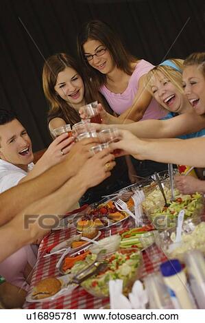 Stock Image - Teenagers toast. Fotosearch