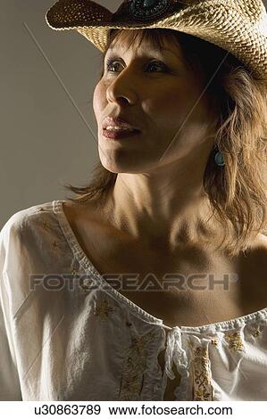 Stock Photo - Woman in straw hat. Fotosearch