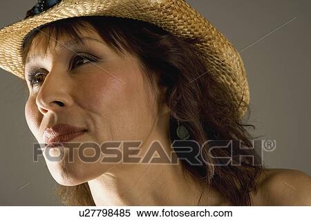 Stock Photography - Woman in straw hat. Fotosearch