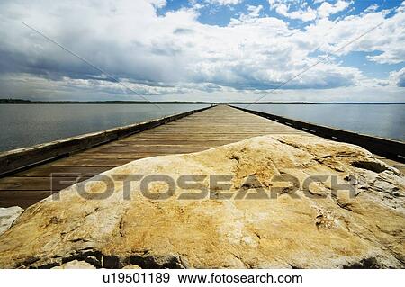 Wooden pier and rock View Large Photo Image Stock Photo - Wooden pier and rock. Fotosearch