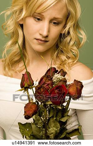Young woman with withered roses View Large Photo Image Stock Image - Young woman with withered roses. Fotosearch