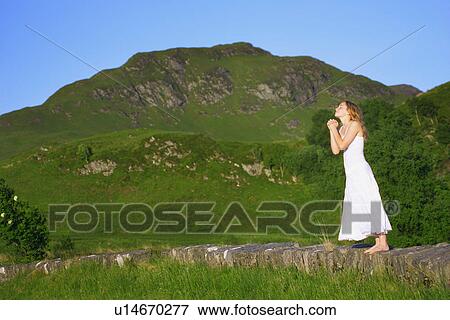 Stock Photo - Praying in the mountains. Fotosearch