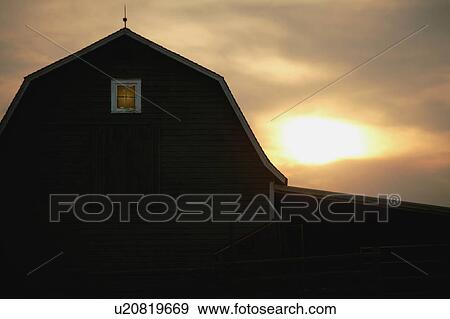 Stock Photo - A barn at sunrise/sunset. Fotosearch