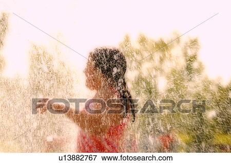 Stock Photo - A child plays in the water. Fotosearch