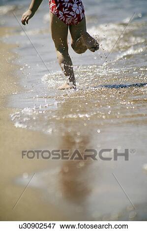 A child runs on the beach View Large Photo Image Stock Photo - A child runs on the beach. Fotosearch