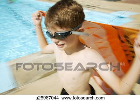 A child runs with a towel View Large Photo Image Picture - A child runs with a towel. Fotosearch