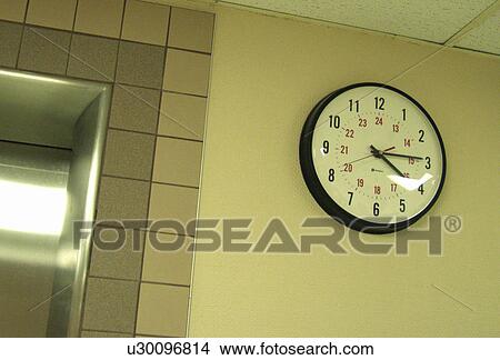 A clock on a wall View Large Photo Image Picture - A clock on a wall. Fotosearch