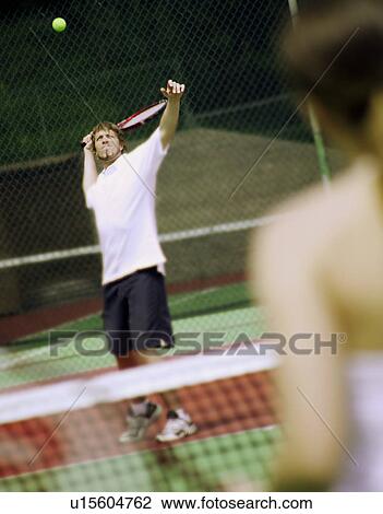 A couple playing tennis View Large Photo Image Stock Image - A couple playing tennis. Fotosearch