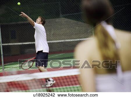 A couple playing tennis View Large Photo Image Stock Image - A couple playing tennis. Fotosearch