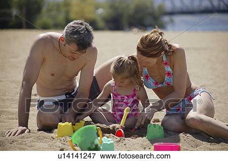 A family on the beach View Large Photo Image Stock Photo - A family on the beach. Fotosearch