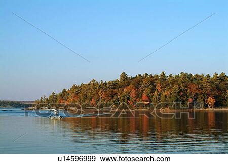 Stock Photo - A float plane on a lake. Fotosearch