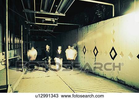 Stock Image - A group walks underground. Fotosearch