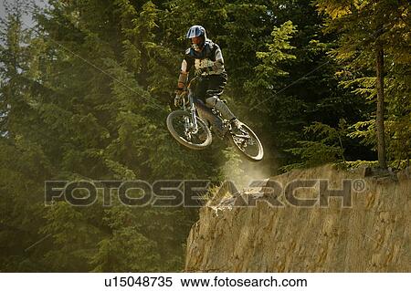 A mountain biker jump View Large Photo Image Stock Photography - A mountain biker jump. Fotosearch