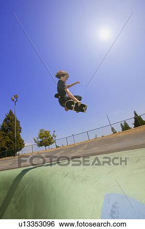 A skater does a trick View Large Photo Image Stock Photograph - A skater does a trick. Fotosearch