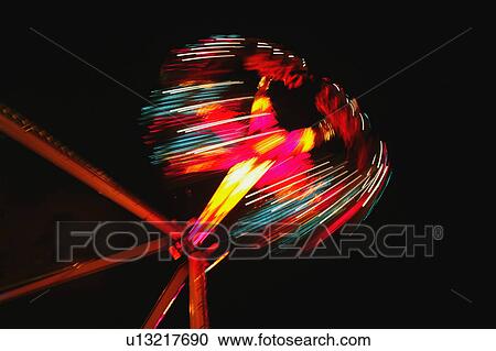 Stock Image - A spinning ride at an amusement park. Fotosearch